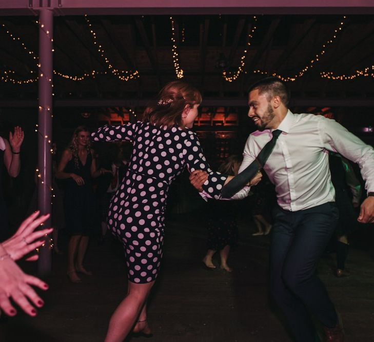 Guests enjoy traditional ceilidh at Scottish wedding