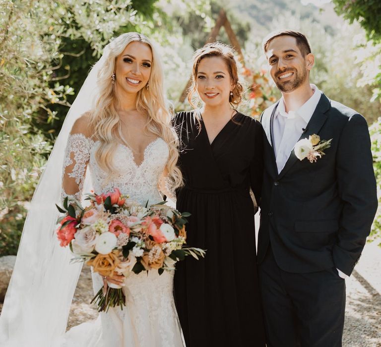 Bride and groom with their celebrant at Bride in lace wedding dress at California elopement