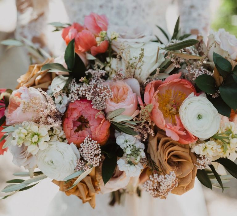 Coral peony, peach roses and white ranunculus  floral bouquet