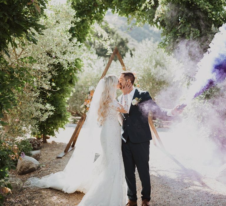 Bride and groom smoke bomb portrait