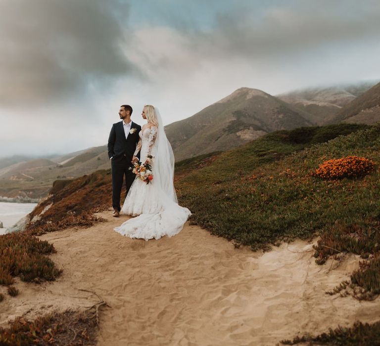 Bride in lace Pronovias wedding dress and groom in navy suit at intimate elopement