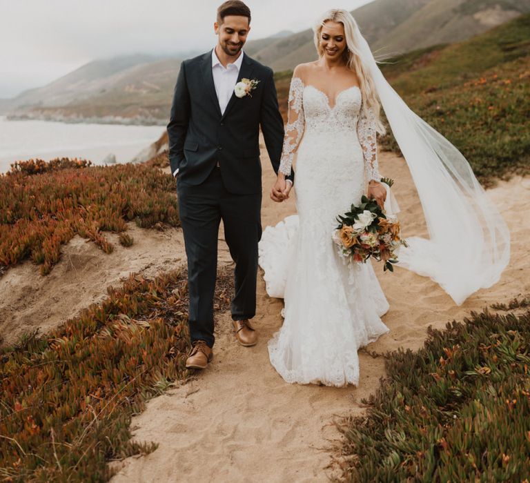 Bride and groom walking hand in hand at California elopement