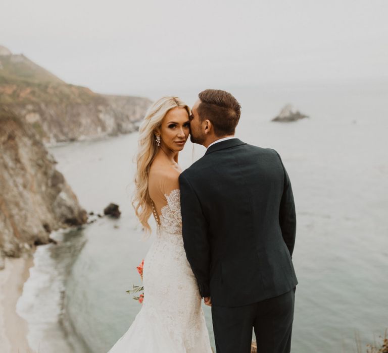 Bride and groom coastal portrait by Ariele Chapman Photography