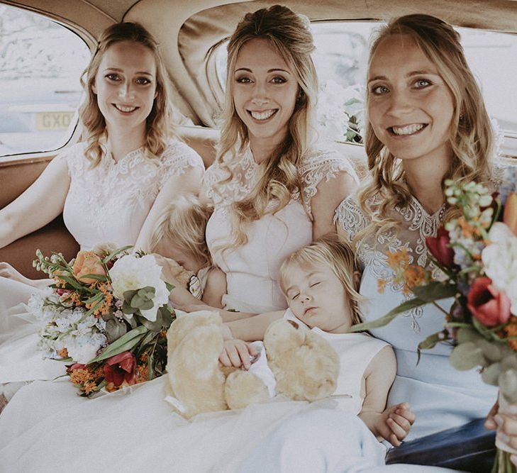 Bridesmaids in Vintage Wedding Car with Bright Bouquets