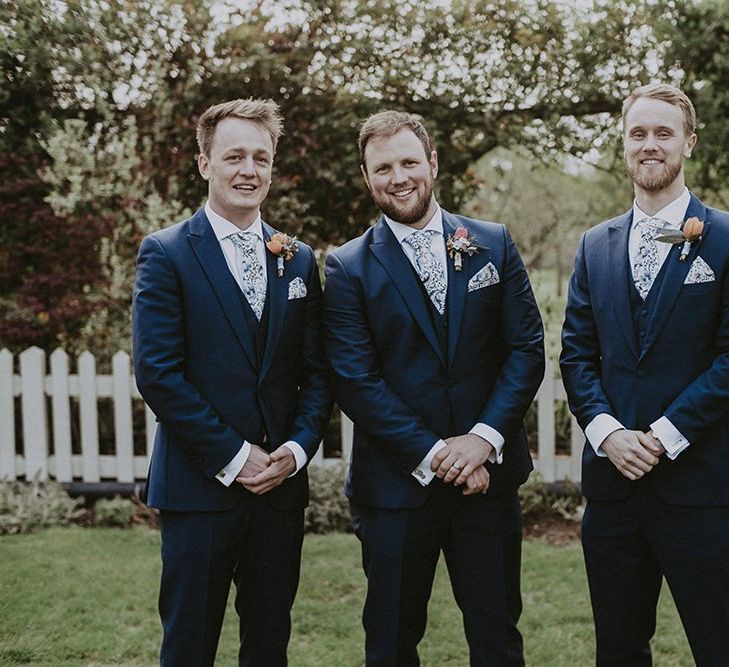 Groomsmen in Three-piece Navy Suit with Floral Tie and Pocket Square