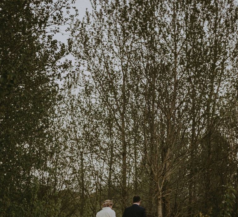 Bride and Groom Walking Through the Countryside