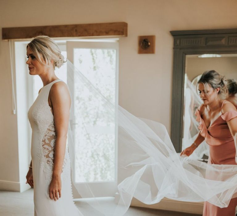 Bride wearing lace panel wedding dress from Justin Alexander