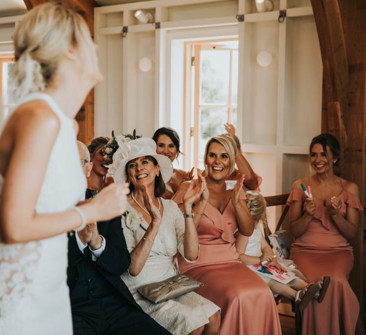 Bridesmaids cheer during wedding ceremony