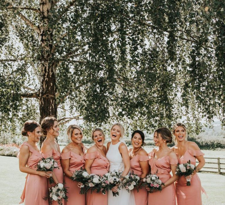 Pink bridesmaid dresses with flower bouquets