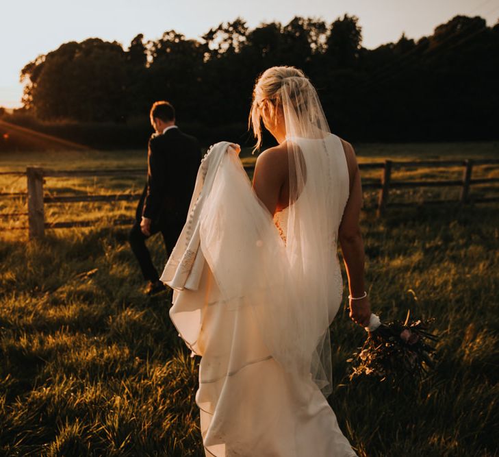 Bridal updo with veil and Justin Alexander wedding dress