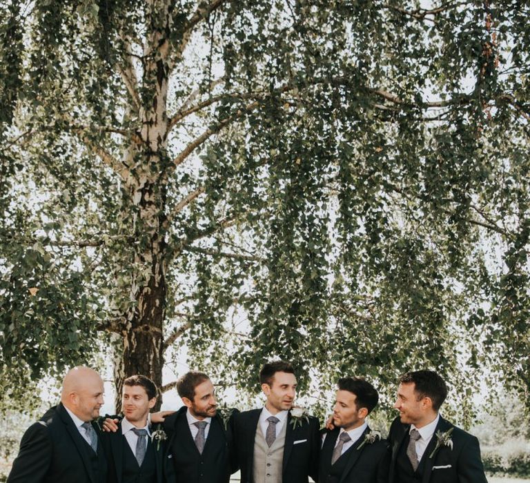 Groom with groomsmen in matching suits