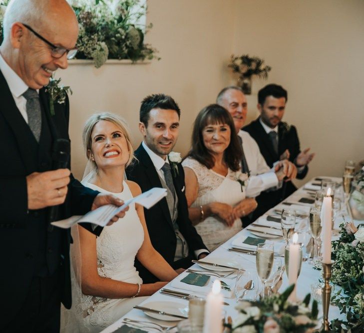 Bride and groom enjoy wedding speeches