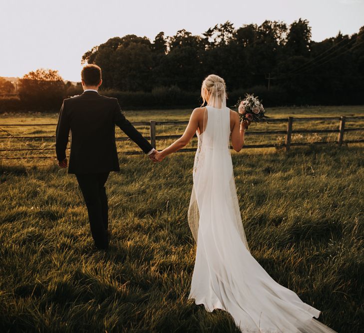 Justin Alexander wedding dress with undo and blush bouquet