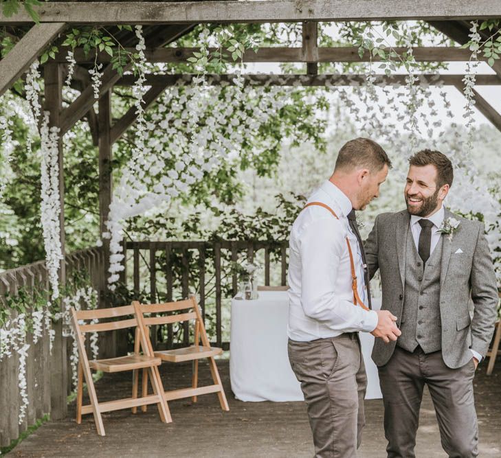 Groom in Three-piece Wool Suit and Best Man in Chino's  and Braces Talking at the Altar