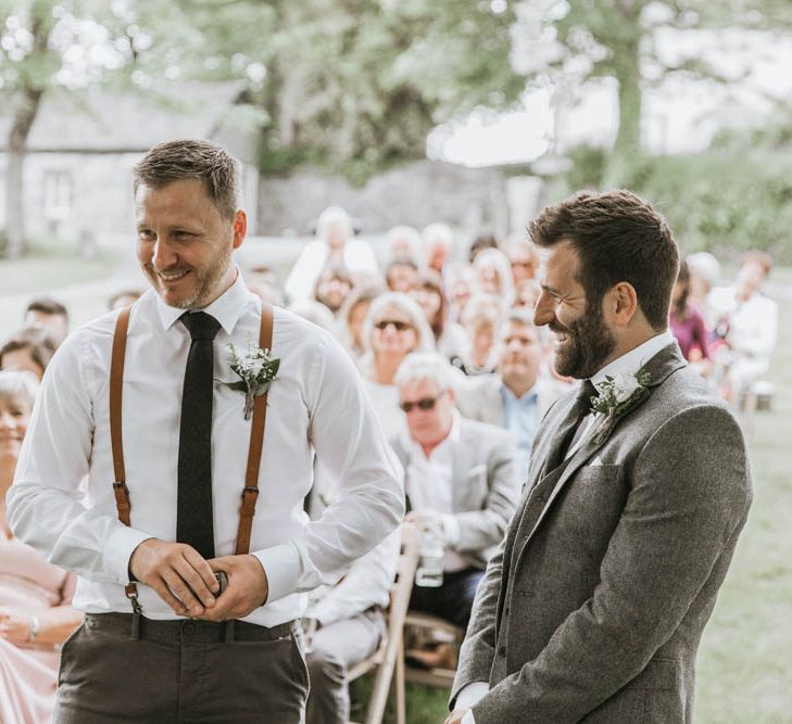 Groom in Three-piece Wool Suit and Best Man in Chino's  and Braces Laughing Together at the Altar