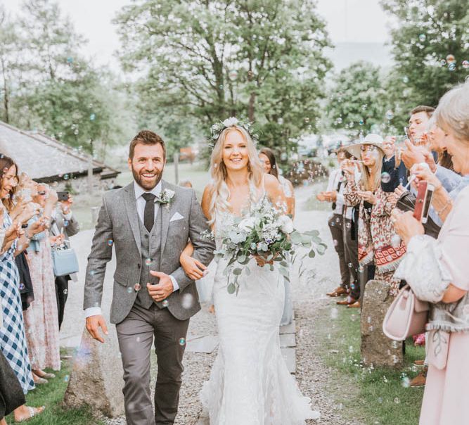 Confetti Moment with Bride in Lace Wedding Dress and Groom in Wool Suit