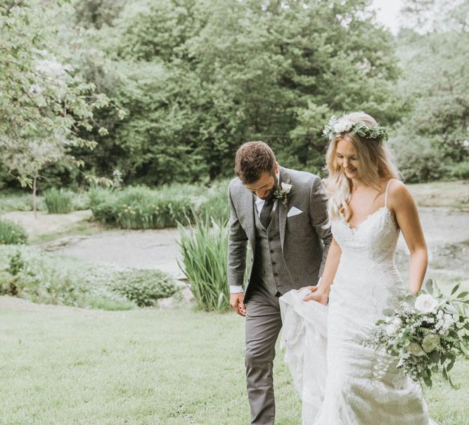 Bride in Lace Wedding Dress and Flowers Crown and Groom in Brown Wool Suit