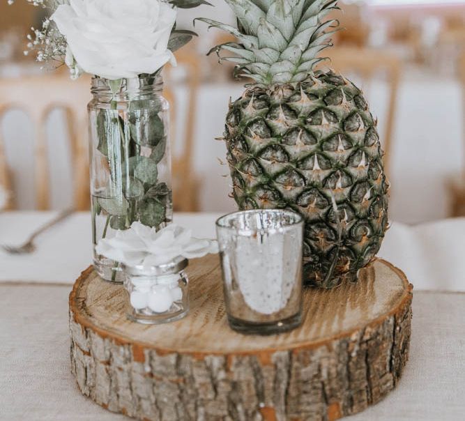 Table Centrepiece with Tree Slice, Pineapple and Flower Stems in Jars