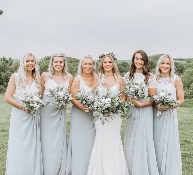 Bridal Party with Bride in Lace Wedding Dress and Flower Crown and Bridesmaids in Separates