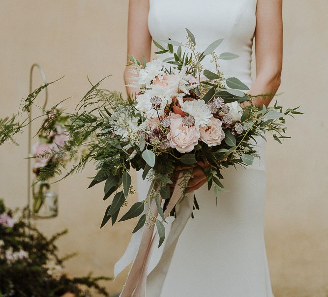 Bride in Fitted Mikaella Bridal Wedding Dress Holding Her Bouquet