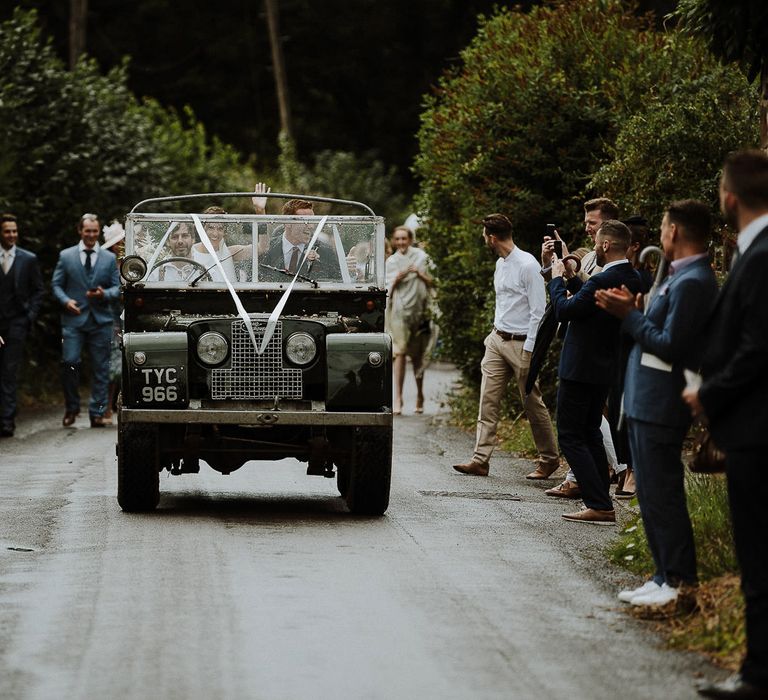 Bride and Groom in Land Rover Wedding Car