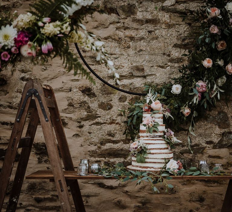 Semi Naked Wedding Cake on Rustic Ladder Table Top with Flower Hoop Backdrop