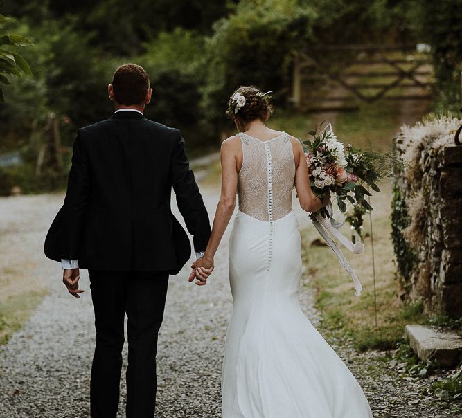 Bride in Lace Back Mikaella Bridal Fitted Wedding Dress and Groom in  Clifton Suit