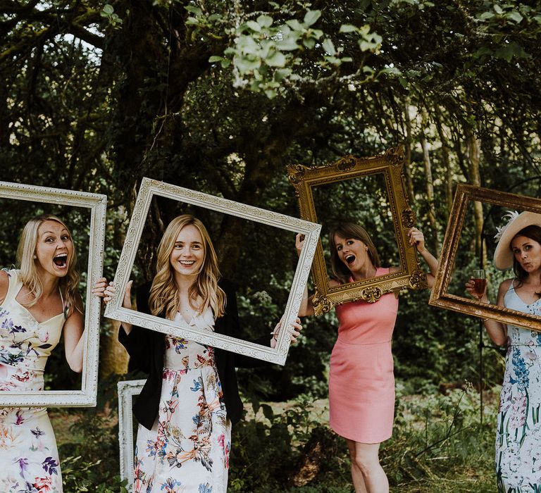 Hanging Picture Frames From Tree as Photo Booth Station