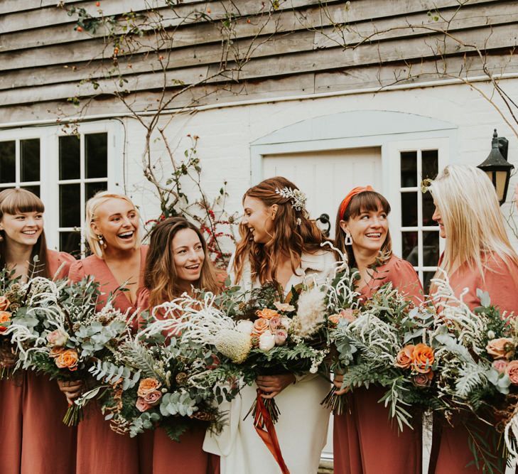 Large bouquet and bridesmaid jumpsuit for November wedding