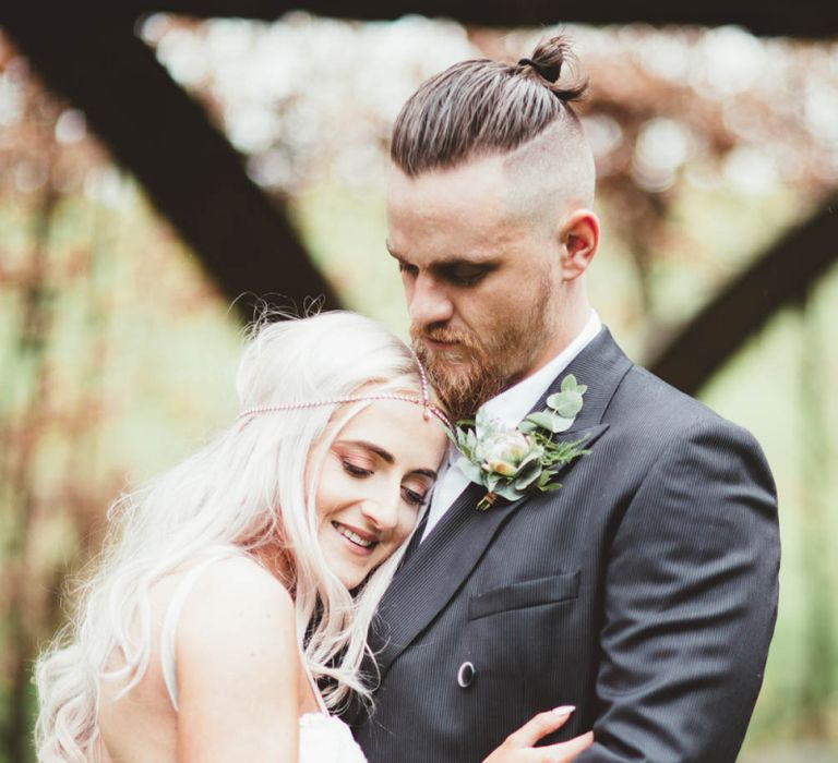 Bride  in Danni Made With Love Bridal  Wedding Dress and Groom in Reiss Suit Embracing