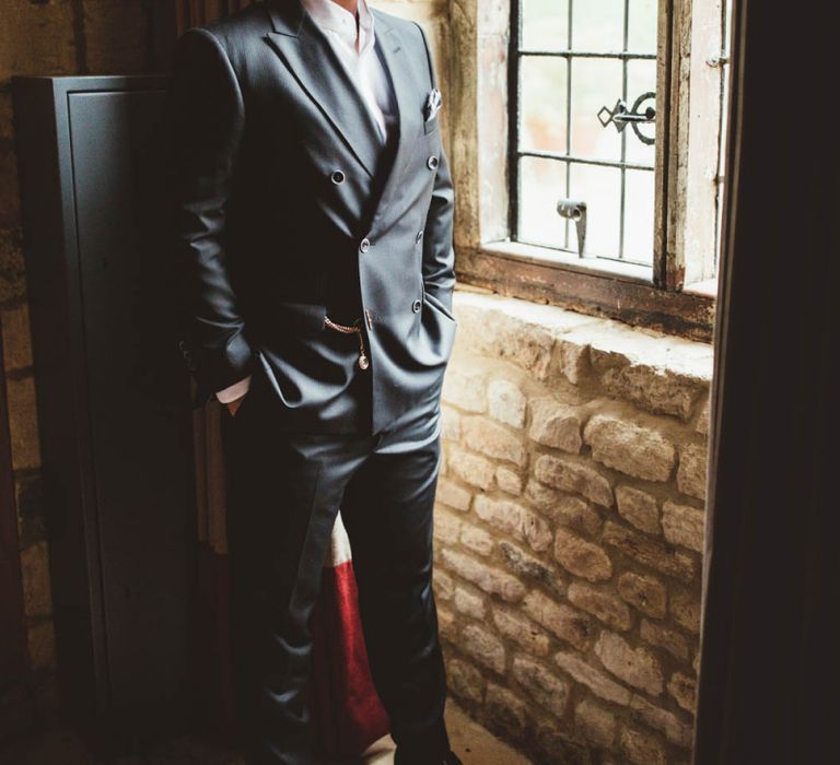 Groom in Reiss Suit Standing by The Window