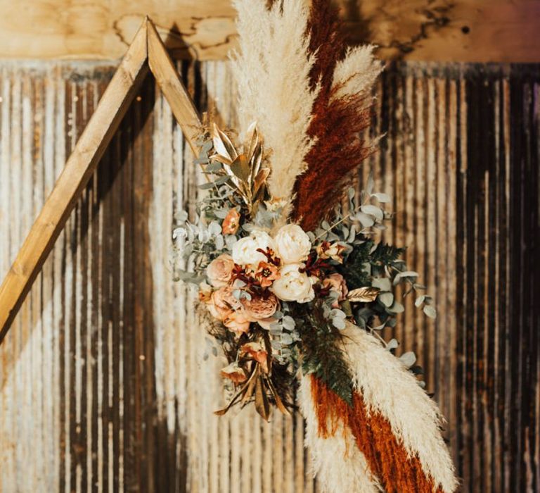 Pampas grass and Autumn flowers with bridesmaid jumpsuit for November wedding