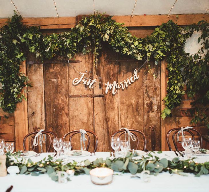 Top Table Back Drop Greenery Floral Arrangement with Copper Just Married Bunting