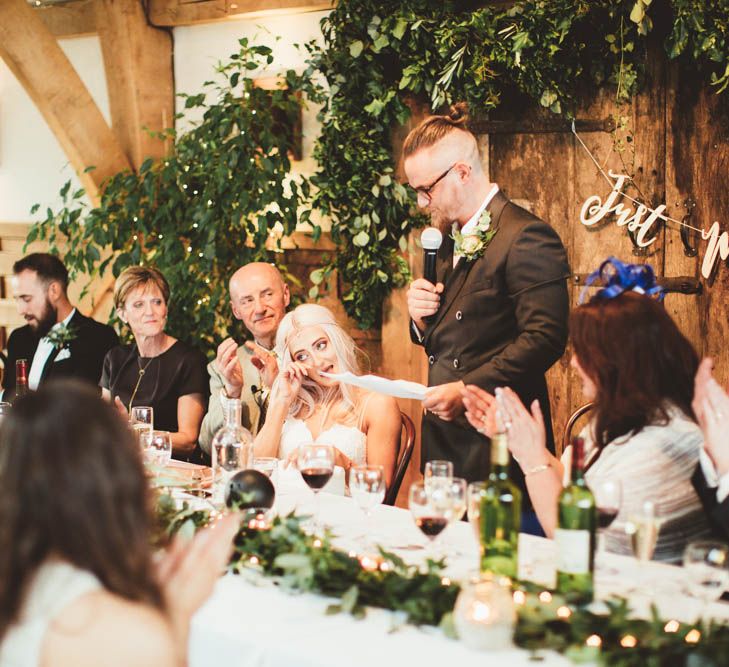 Groom in Reiss Suit  Giving His Wedding Speech with Greenery Back Drop and Copper Just Married Bunting