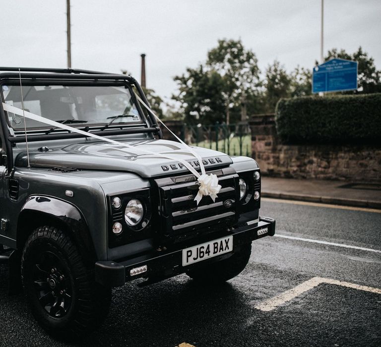 Defender wedding car with white ribbon and multiway bridesmaid dresses