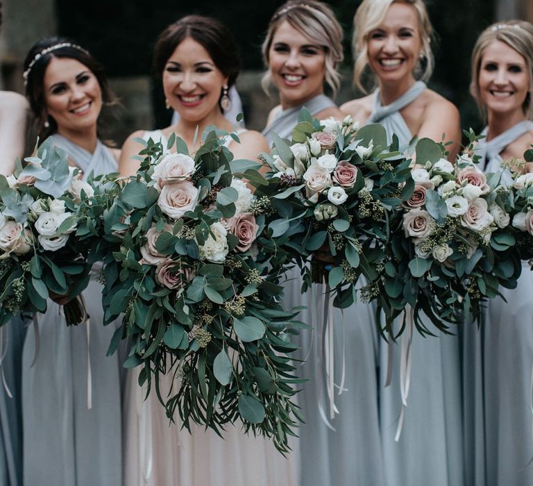 Bridal party bouquets with eucalyptus and roses.