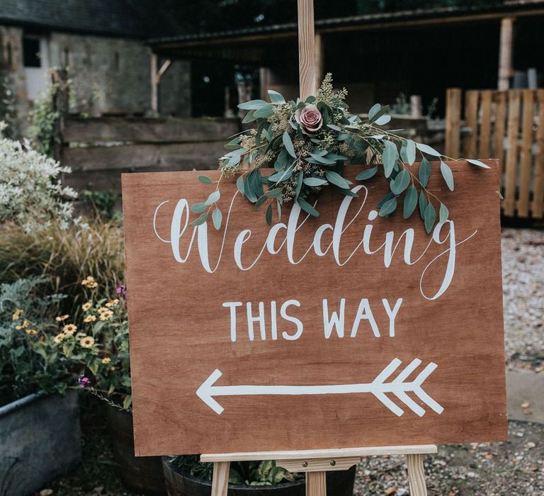 Wooden wedding welcome sign with flowers