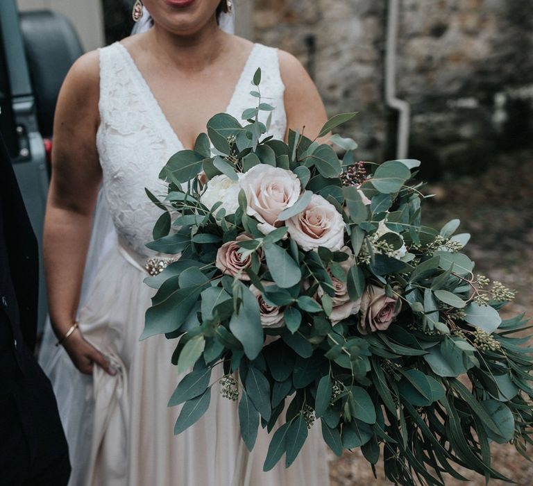 Oversized bridal bouquet with eucalyptus, roses and sweet September flowers.