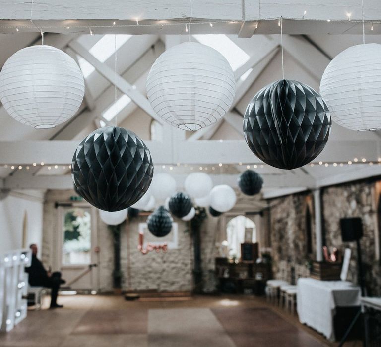 Grey and white hanging paper lanterns and honey comb balls