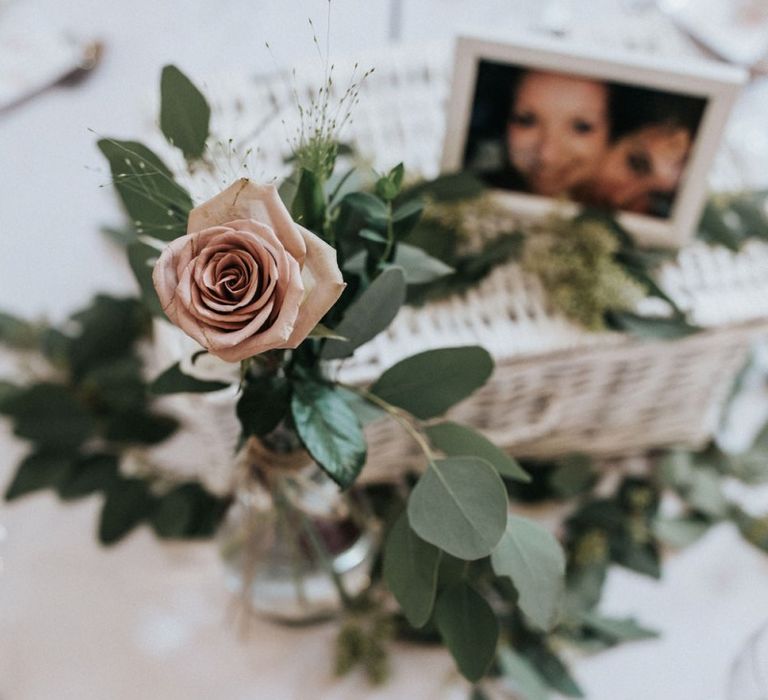 Flower centrepiece with eucalyptus and roses.