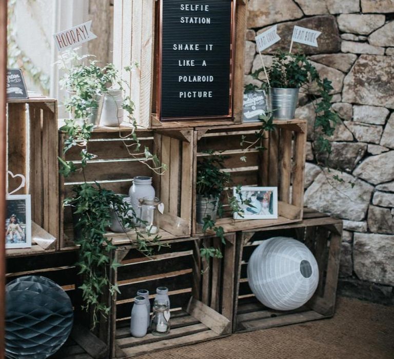 Selfie station wedding decor with crates and peg board sign