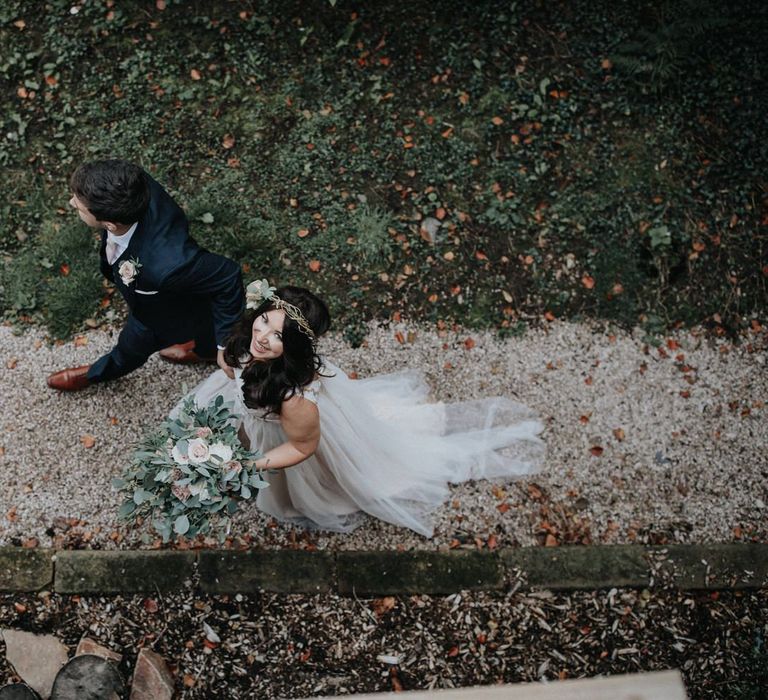 Bride and groom walking hand in hand for wedding with multiway bridesmaid dresses