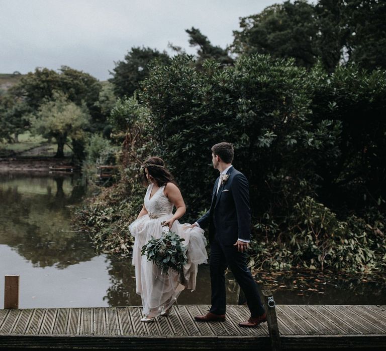 Bride and groom portrait on the dock for wedding with multiway bridesmaid dresses