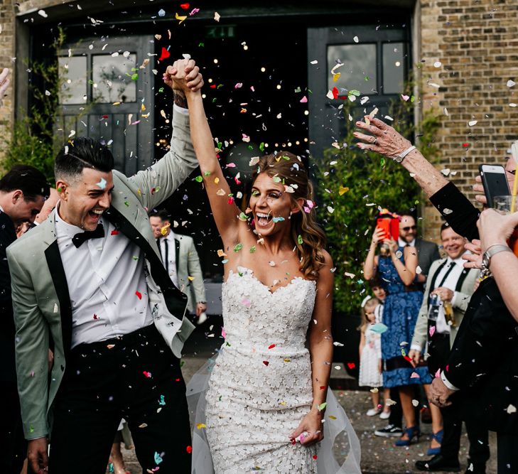 Confetti Moment with Bride in Tara Keely Wedding Dress and Groom in Grey Tuxedo Jacket