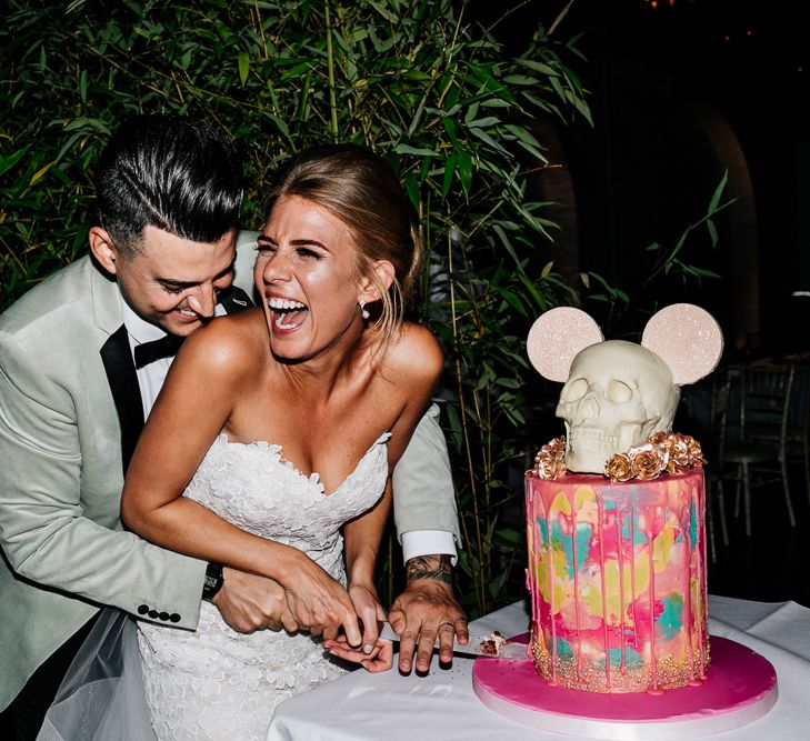 Bride and Groom Cutting Their Wedding Cake