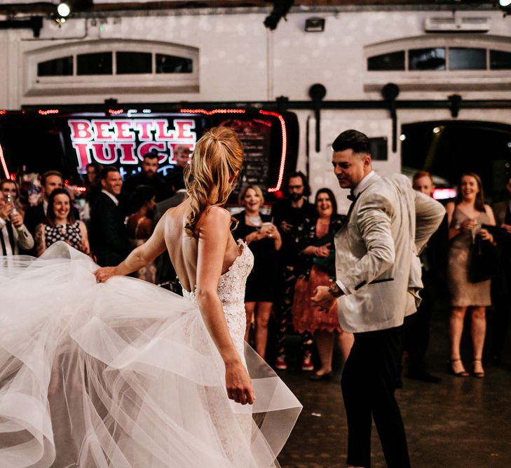 First Dance with Bride in Tara Keely Wedding Dress with Organza Skirt Detail and Groom in Grey Tuxedo Jacket.