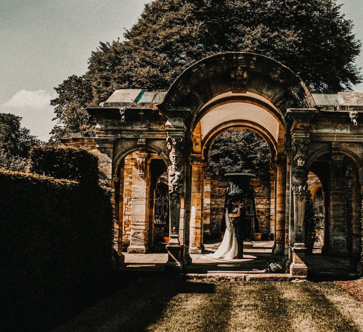 Bride in  Appliqué Flowers Yolan Cris ‘Espino’ Wedding Dress | Groom in Grey's Suit Hire | Pre-Raphaelite Mood Wedding at Heaver Castle in Kent | Carla Blain Photography