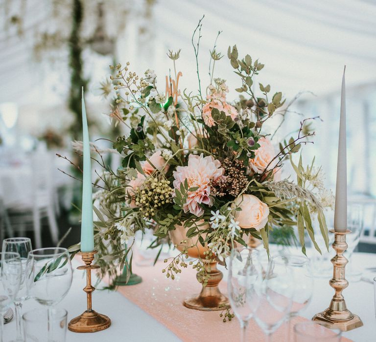 Earthy toned florals with coloured tapered candles | Bespoke Planning and Styling by Helaina Storey Wedding Design | Image by Alice Cunliffe Photography