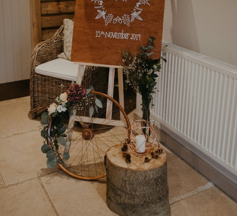 Wooden wedding welcome sign and rustic decor at Lapstone Barn