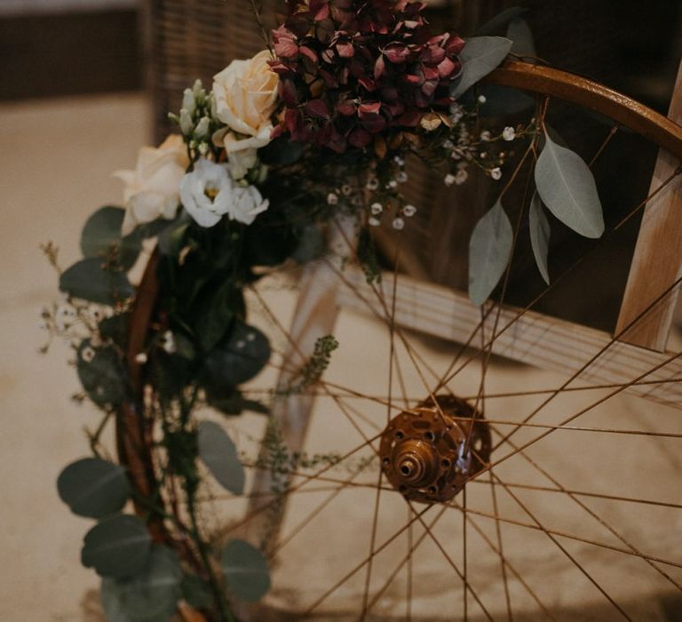 Vintage wheel wedding decor covered in flowers